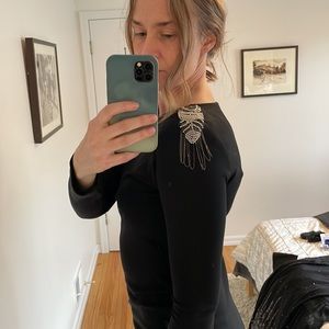 Teenflo dress black stretchy material with shoulder pads and metal detailing